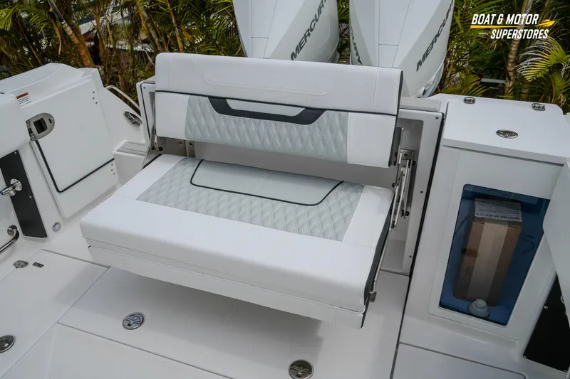  Yacht Photos Pics 2026 Blackfin 272 DC boat seating area with white upholstery and storage compartments.
