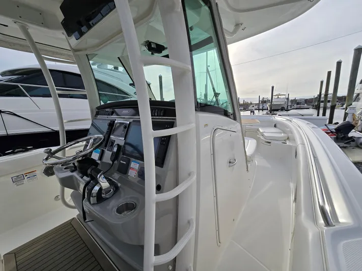  Yacht Photos Pics 2015 Boston Whaler 350 Outrage helm with modern controls and navigation equipment.