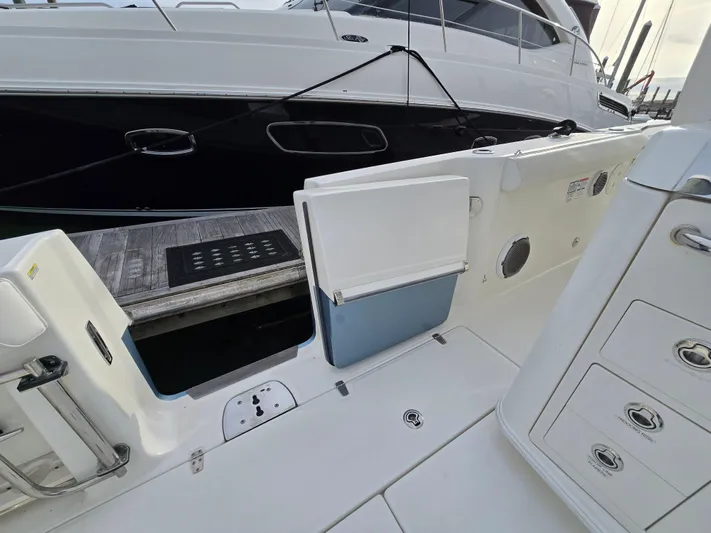  Yacht Photos Pics 2015 Boston Whaler 350 Outrage boat interior with open side door and dock view.