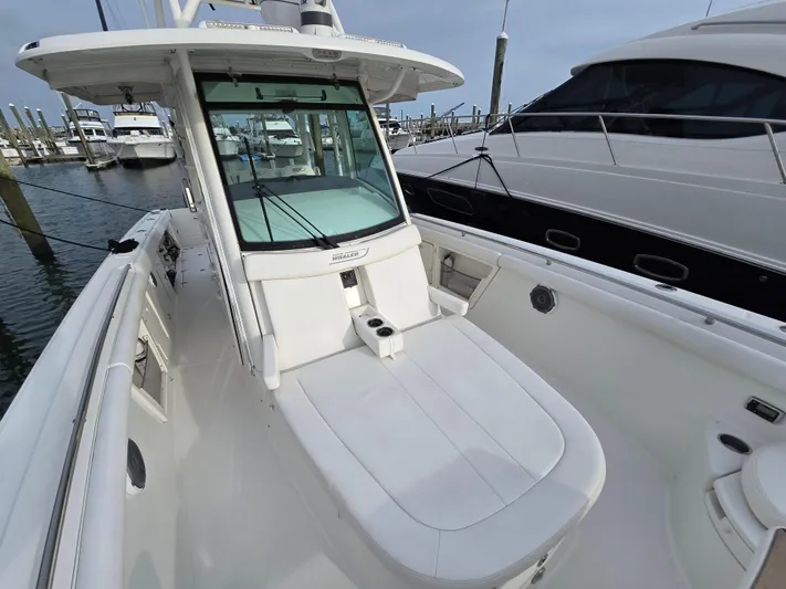  Yacht Photos Pics 2015 Boston Whaler 350 Outrage boat docked, showcasing sleek design and spacious deck.