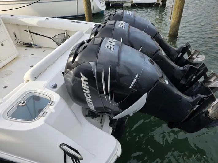  Yacht Photos Pics 2015 Boston Whaler 350 Outrage with triple Mercury 300 engines docked in marina.