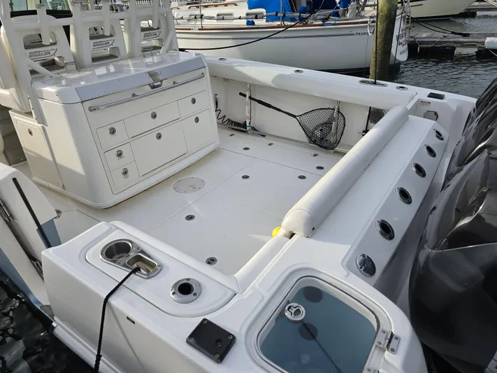  Yacht Photos Pics 2015 Boston Whaler 350 Outrage boat deck with seating and storage, docked at marina.