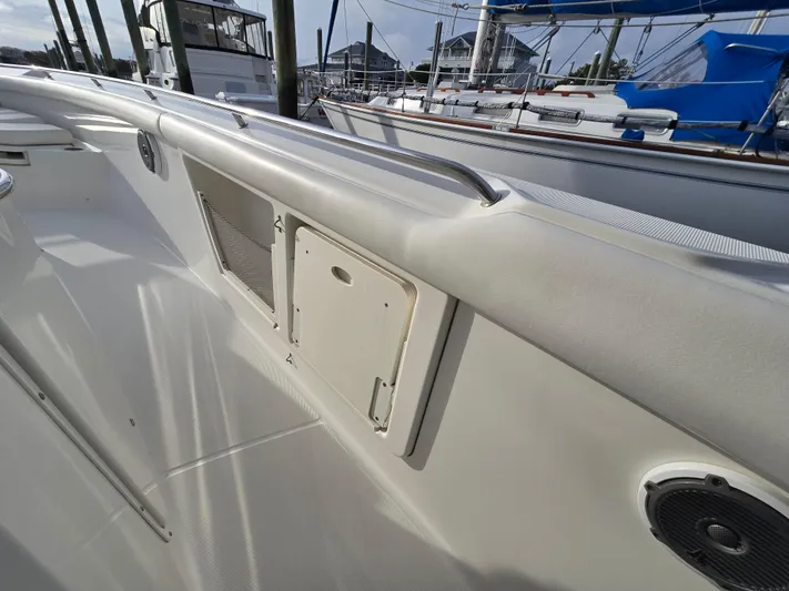  Yacht Photos Pics 2015 Boston Whaler 350 Outrage boat deck with storage compartments and railing.