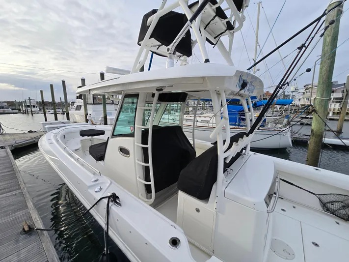  Yacht Photos Pics 2015 Boston Whaler 350 Outrage docked at marina, showcasing sleek design and spacious deck.