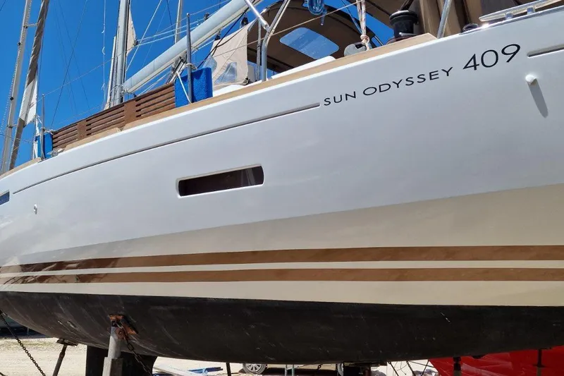  Yacht Photos Pics 2013 Jeanneau Sun Odyssey 409 sailboat on land, showcasing sleek design and modern features.