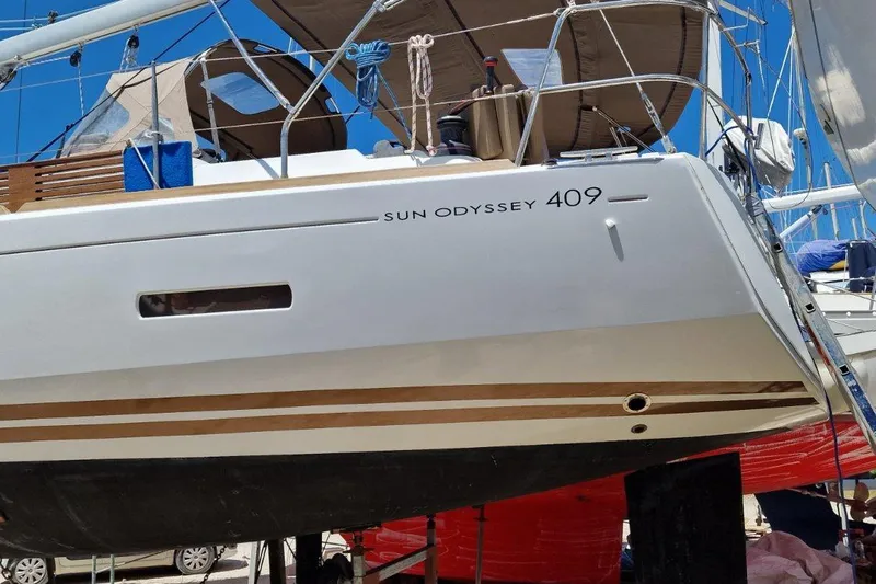  Yacht Photos Pics 2013 Jeanneau Sun Odyssey 409 sailboat on dry dock, showcasing sleek design and modern features.