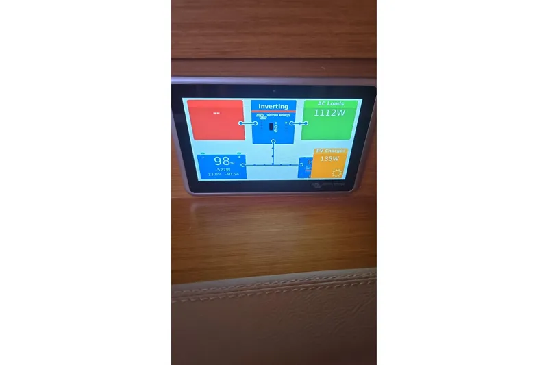  Yacht Photos Pics Control panel display on 2013 Jeanneau Sun Odyssey 409 sailboat, showing power usage and charging.