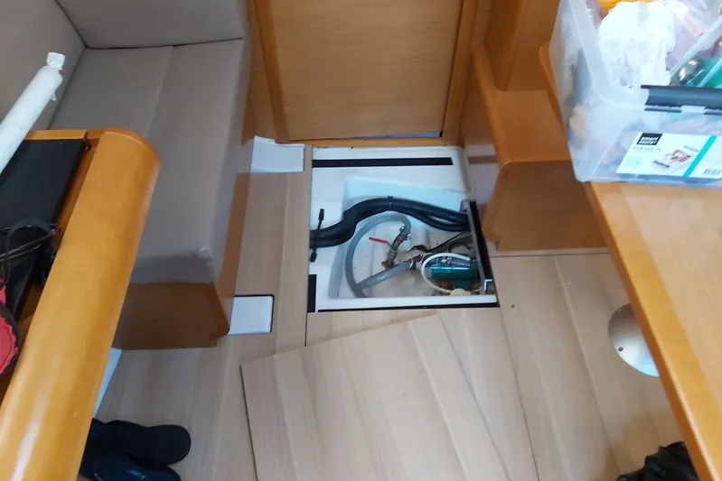  Yacht Photos Pics Interior view of 2013 Jeanneau Sun Odyssey 409 sailboat, showing open floor hatch and storage.