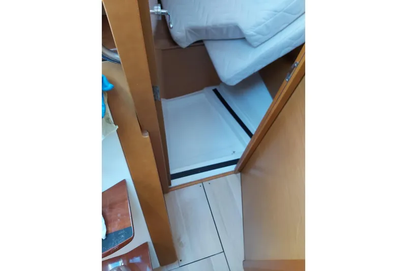  Yacht Photos Pics Interior view of 2013 Jeanneau Sun Odyssey 409 sailboat cabin with wooden finish.