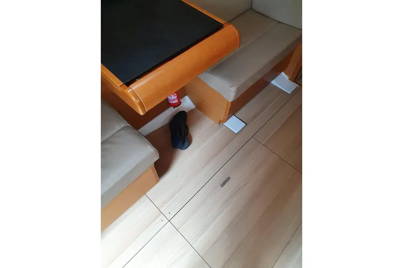  Yacht Photos Pics Interior of 2013 Jeanneau Sun Odyssey 409 yacht with seating and table.