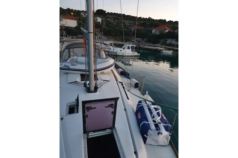  Yacht Photos Pics 2013 Jeanneau Sun Odyssey 409 sailboat docked in a serene harbor setting.