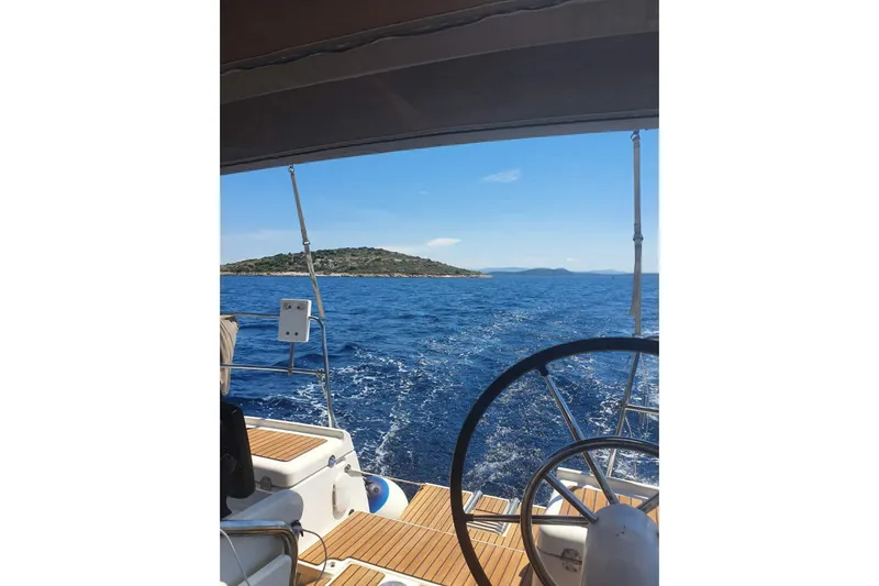  Yacht Photos Pics Sailing view from Jeanneau Sun Odyssey 409, 2013 model, with ocean and island backdrop.