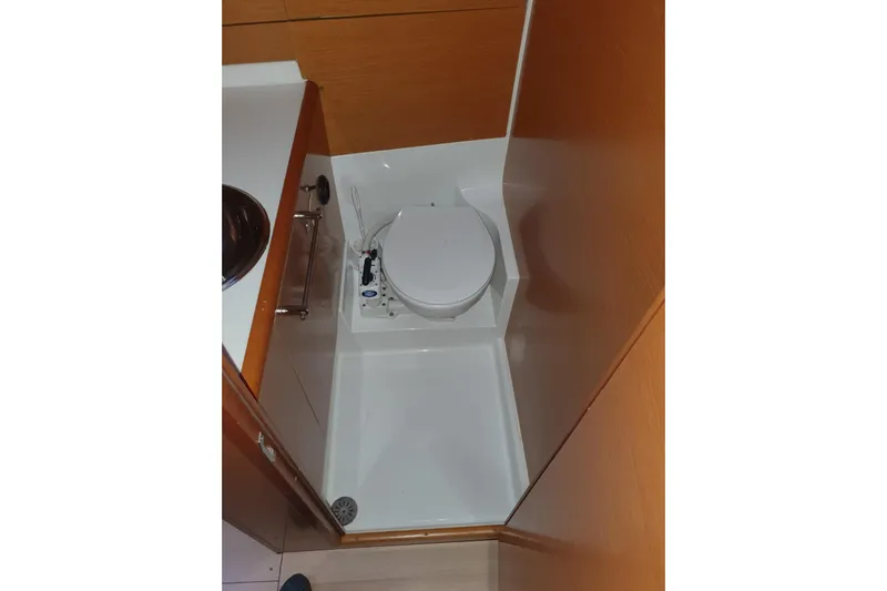  Yacht Photos Pics Bathroom area of 2013 Jeanneau Sun Odyssey 409 yacht, featuring a compact toilet.