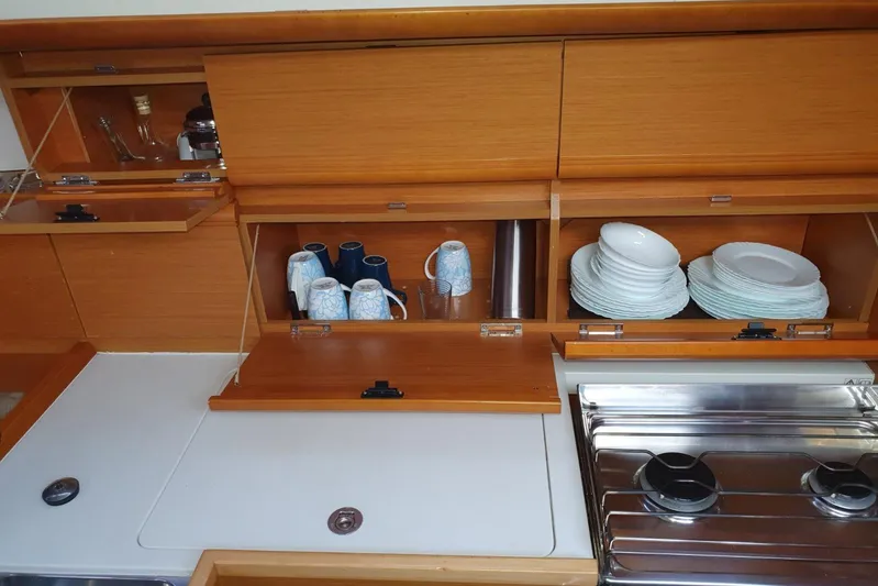  Yacht Photos Pics Galley of 2013 Jeanneau Sun Odyssey 409 with wooden cabinets and kitchenware.