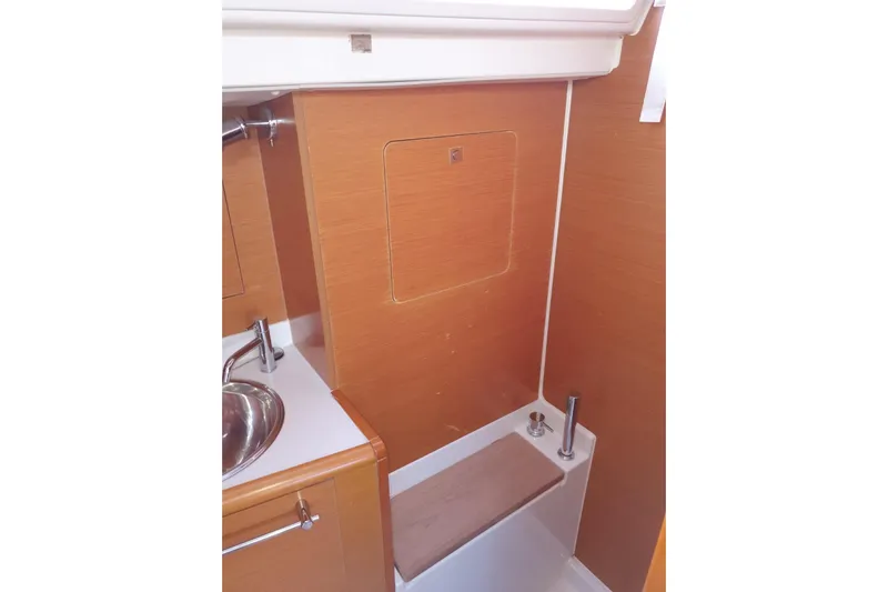 Yacht Photos Pics 2013 Jeanneau Sun Odyssey 409 bathroom with wooden paneling and stainless steel sink.
