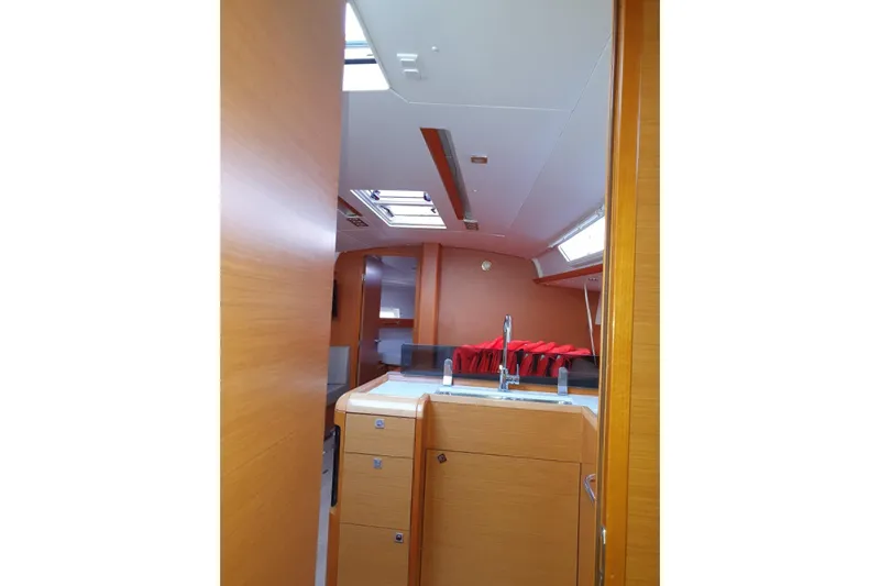  Yacht Photos Pics Interior of 2013 Jeanneau Sun Odyssey 409 sailboat with modern wood finish and skylights.