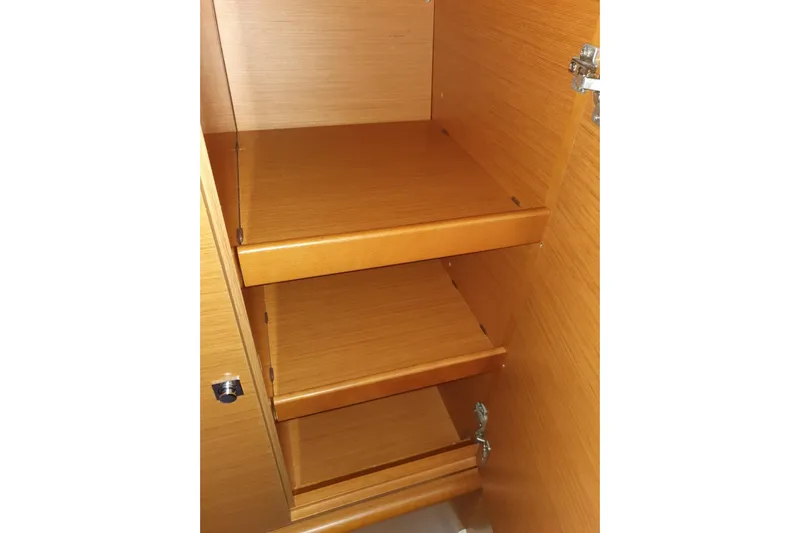  Yacht Photos Pics Wooden interior shelving of a 2013 Jeanneau Sun Odyssey 409 sailboat.
