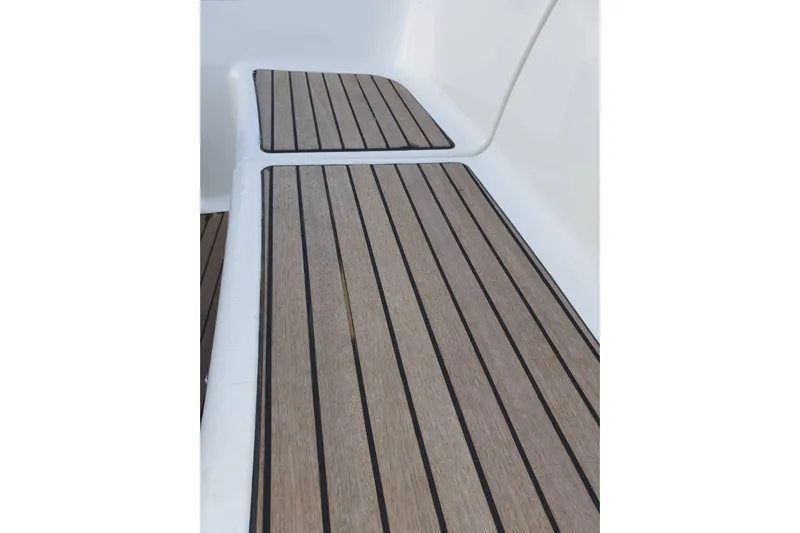  Yacht Photos Pics Teak deck of 2013 Jeanneau Sun Odyssey 409 sailboat, showcasing elegant wood finish.