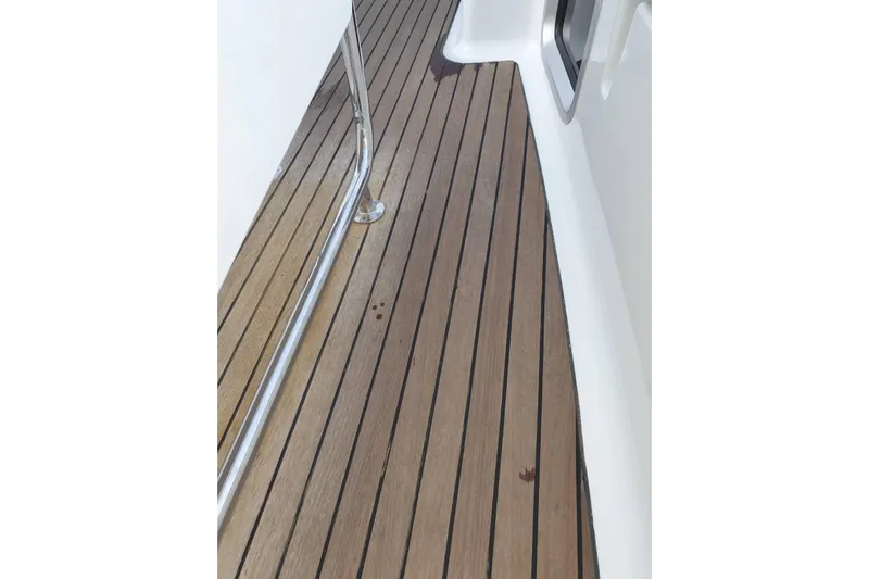  Yacht Photos Pics Teak deck of 2013 Jeanneau Sun Odyssey 409 sailboat with stainless steel railing.