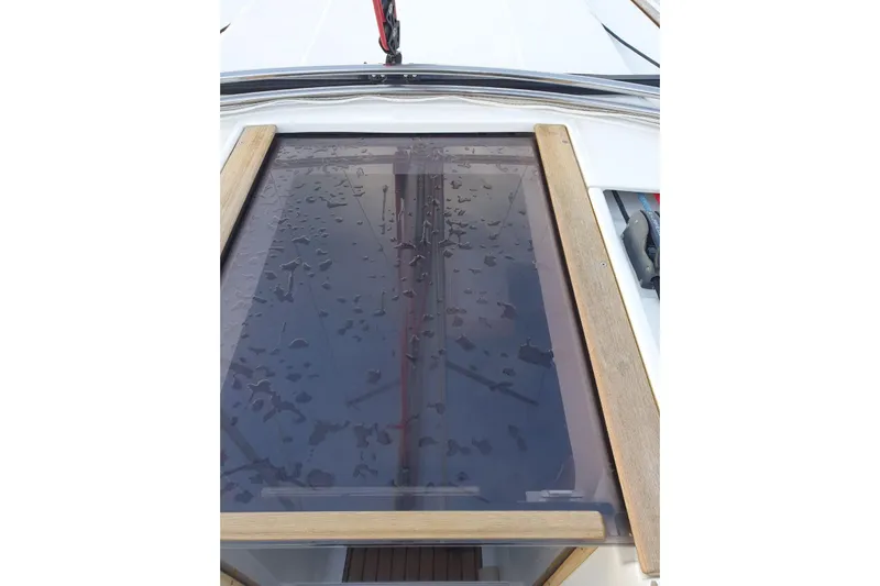 Yacht Photos Pics Hatch of 2013 Jeanneau Sun Odyssey 409 with water droplets on glass surface.