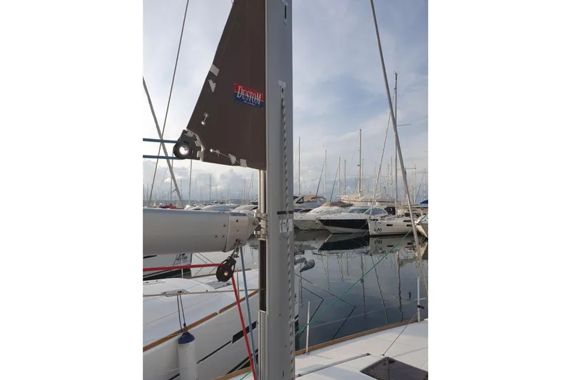  Yacht Photos Pics 2013 Jeanneau Sun Odyssey 409 sailboat mast in marina, surrounded by other boats.