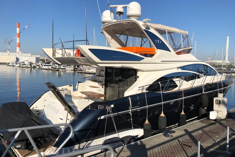  Yacht Photos Pics Luxury 2014 Azimut Fly 60 yacht docked at marina under clear blue sky.