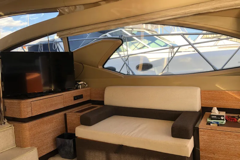  Yacht Photos Pics Interior of 2014 Azimut Fly 60 yacht with sofa and TV, docked at marina.