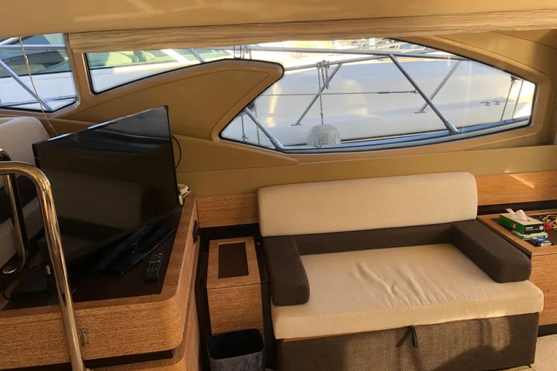  Yacht Photos Pics Interior of 2014 Azimut Fly 60 yacht with sofa and TV, showcasing luxury design.
