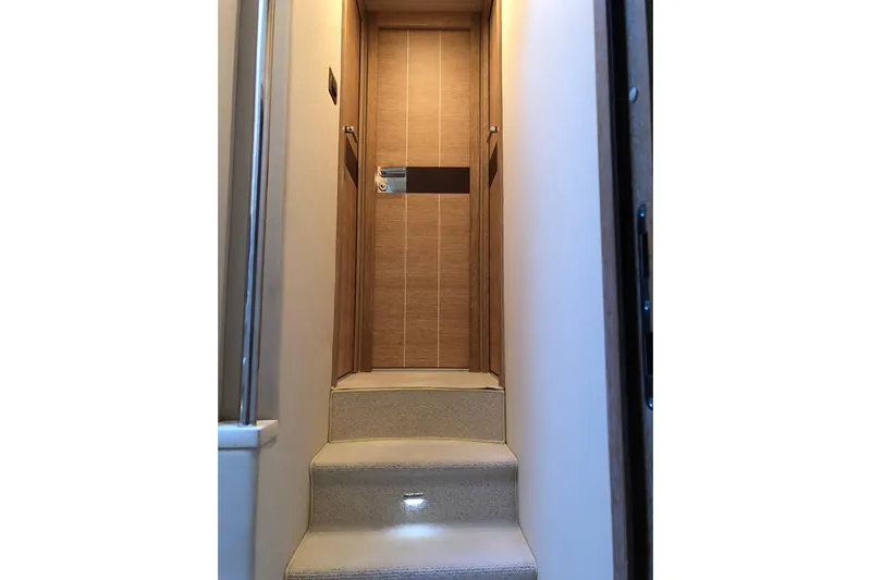  Yacht Photos Pics Interior stairs of 2014 Azimut Fly 60 yacht with wooden door.