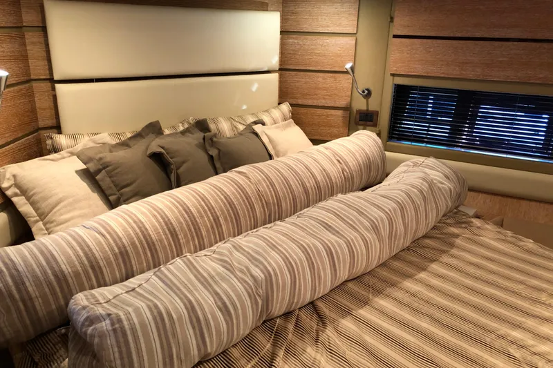  Yacht Photos Pics Luxurious bedroom interior of 2014 Azimut Fly 60 yacht with striped bedding and cushions.