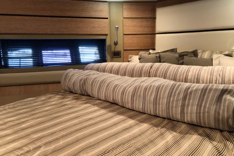  Yacht Photos Pics Luxurious bedroom interior of 2014 Azimut Fly 60 yacht with striped bedding.