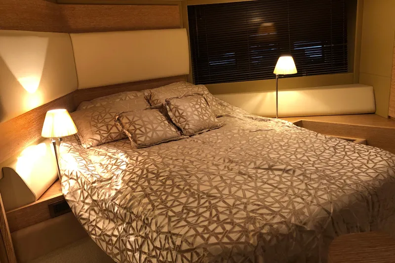  Yacht Photos Pics Luxurious bedroom interior of 2014 Azimut Fly 60 yacht with elegant bedding and warm lighting.