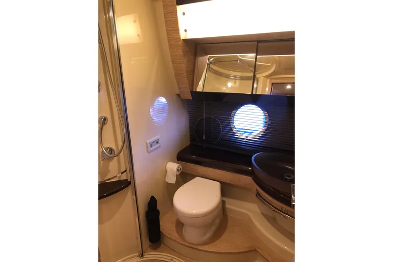  Yacht Photos Pics Luxurious bathroom in 2014 Azimut Fly 60 yacht with modern fixtures and porthole window.