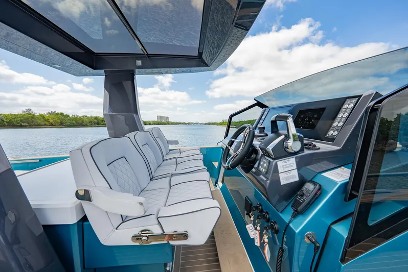 Strade Blu Yacht Photos Pics 2024 Fiart 39 Seawalker cockpit with modern controls and seating, overlooking serene waters.