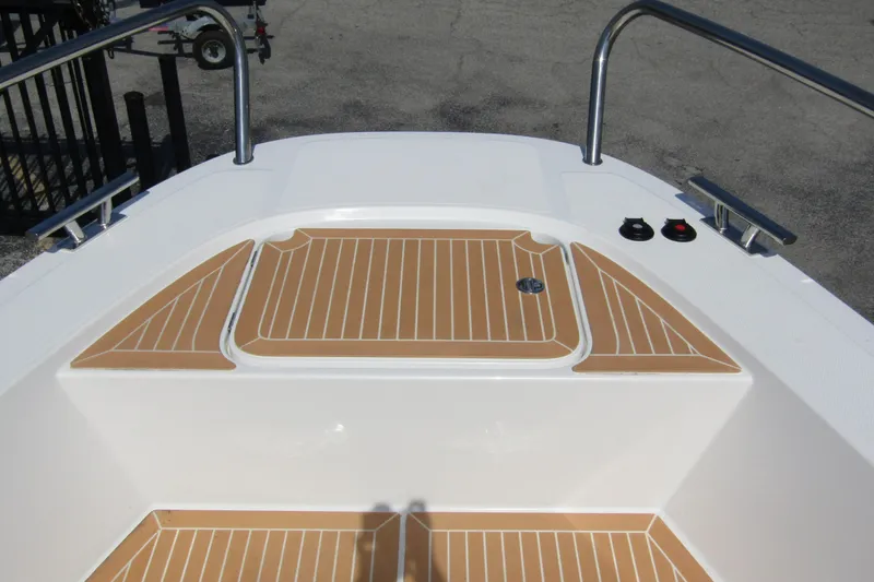  Yacht Photos Pics 2025 Nimbus Commuter 11 boat deck with teak-style flooring and stainless steel railings.