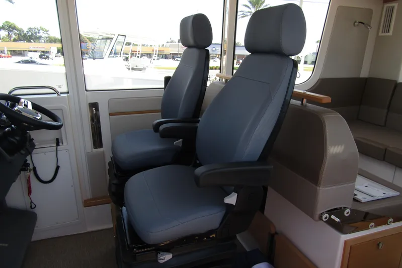  Yacht Photos Pics Interior of 2025 Nimbus Commuter 11 with two modern captain chairs.