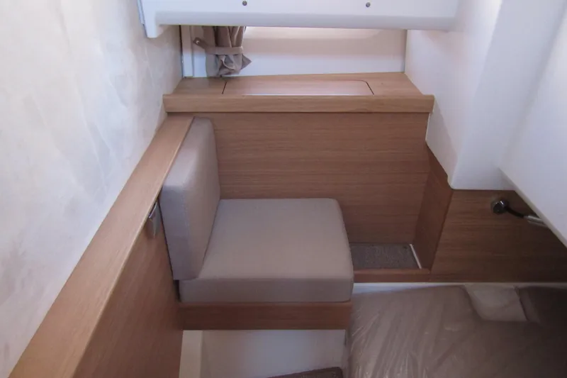  Yacht Photos Pics Compact interior seating area in 2025 Nimbus Commuter 11 with wooden accents.