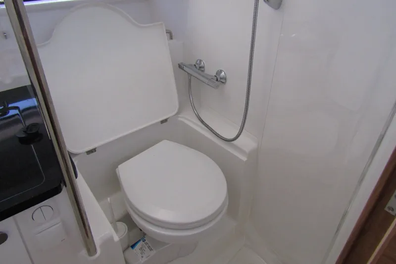  Yacht Photos Pics Compact bathroom in 2025 Nimbus Commuter 11 with toilet and shower.