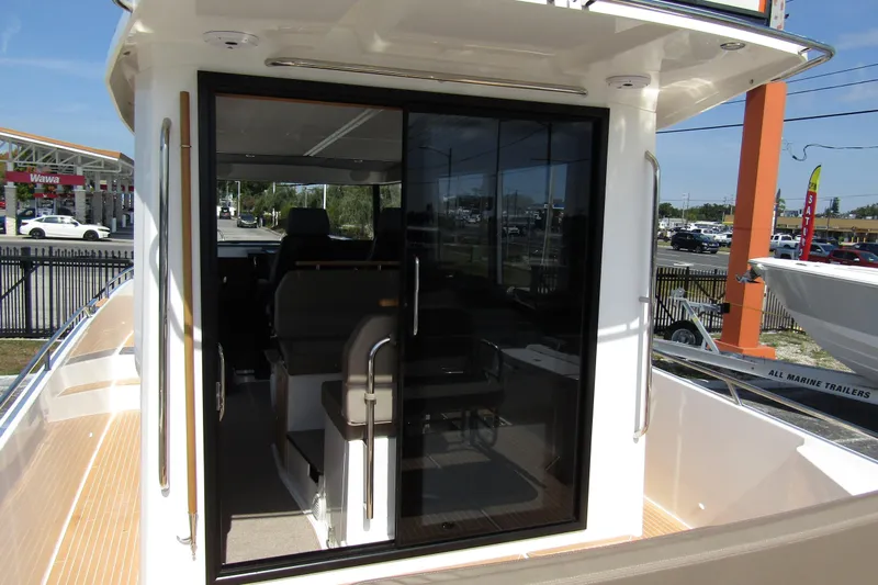  Yacht Photos Pics Nimbus Commuter 11 (2025) boat interior with sliding glass door and modern seating.