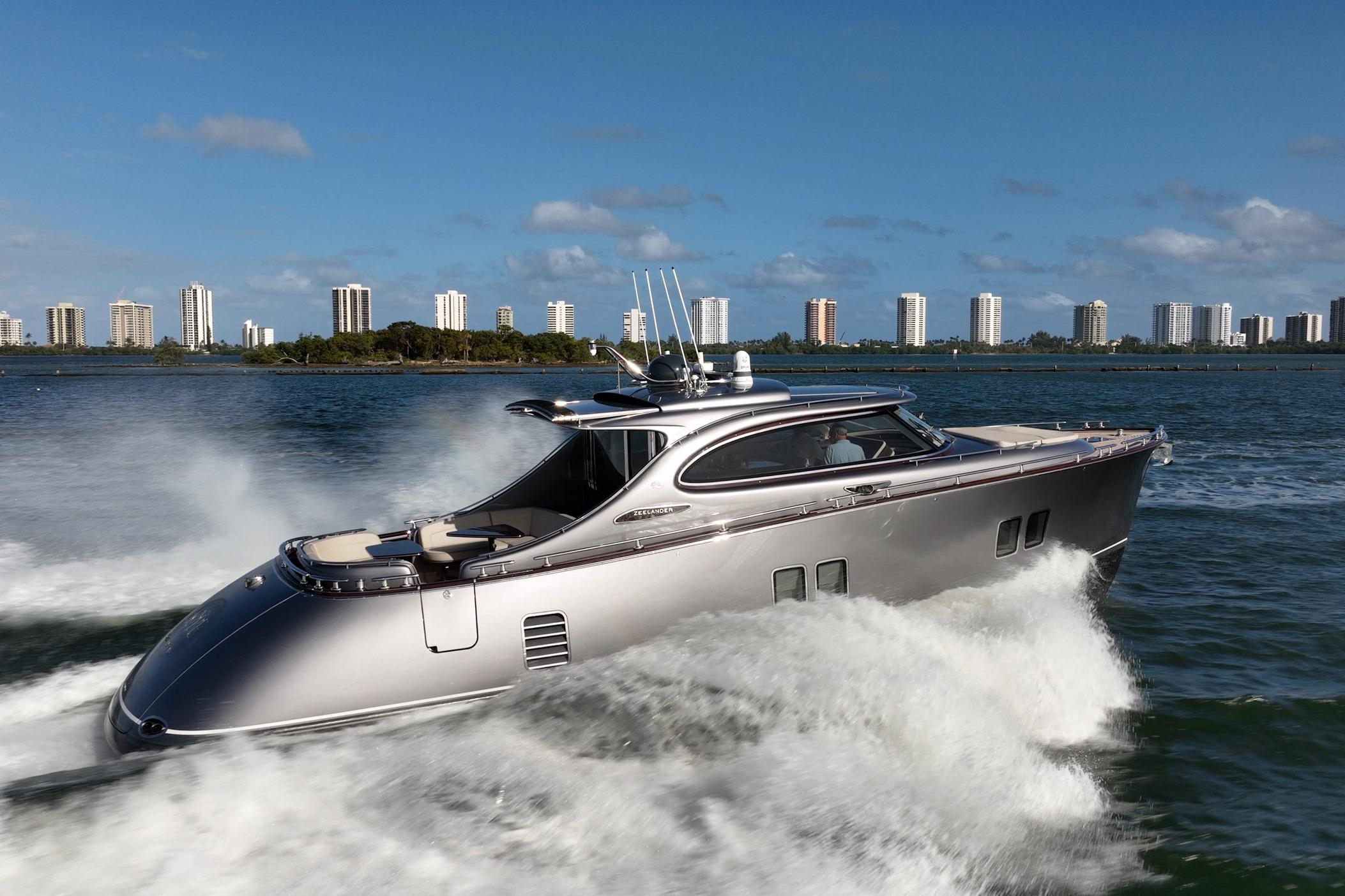 2025 Zeelander Z5 yacht cruising on water with city skyline in background.