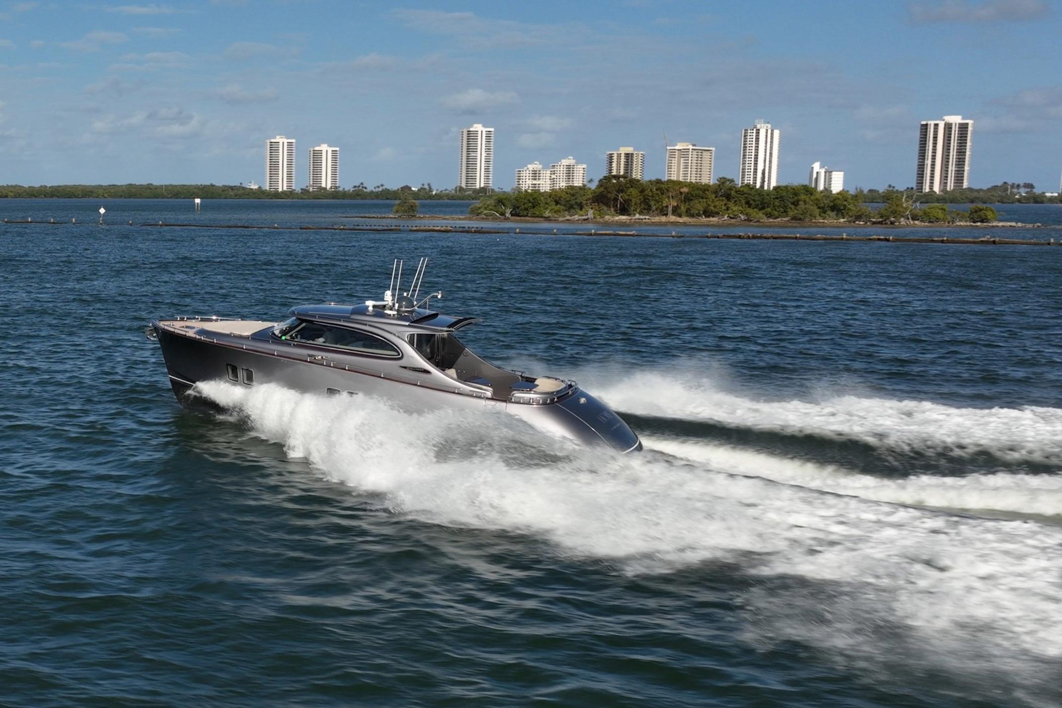 2025 Zeelander Z5 yacht cruising on open water with city skyline backdrop.