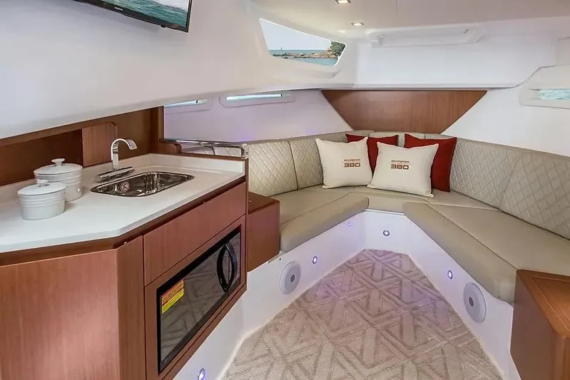  Yacht Photos Pics Luxurious interior of 2025 Schaefer 380 yacht with kitchenette and cozy seating area.