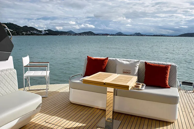  Yacht Photos Pics Luxury Schaefer 380 yacht deck with seating, table, and scenic water view, 2025 model.