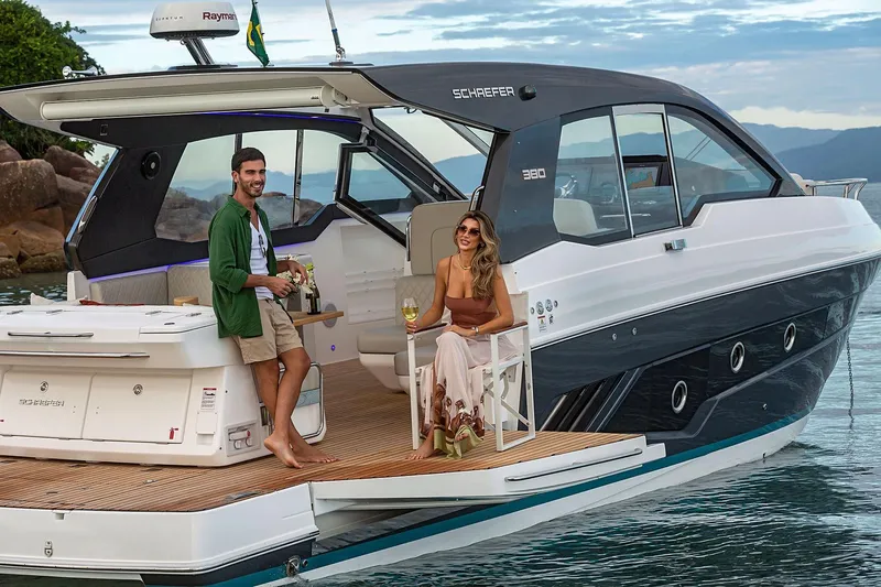  Yacht Photos Pics Couple enjoying leisure time on a 2025 Schaefer 380 yacht, docked by scenic waters.