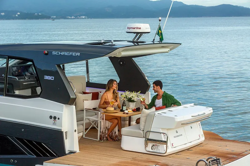  Yacht Photos Pics Couple enjoying a meal on a 2025 Schaefer 380 yacht, with scenic ocean backdrop.