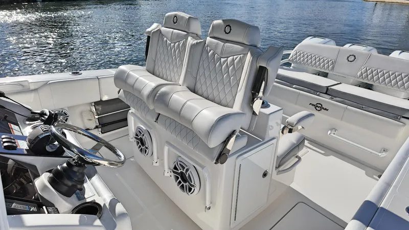  Yacht Photos Pics Luxurious 2022 Fountain 38TE boat interior with plush seating and modern steering console.