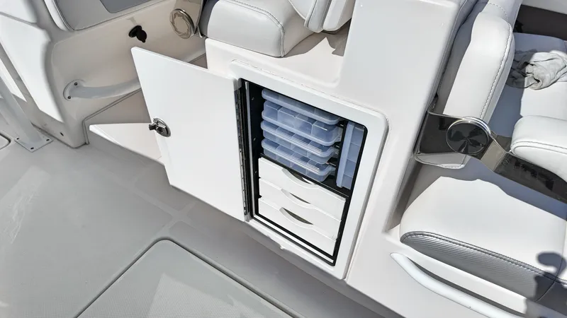  Yacht Photos Pics Open storage compartment on 2022 Fountain 38TE boat with organized containers.