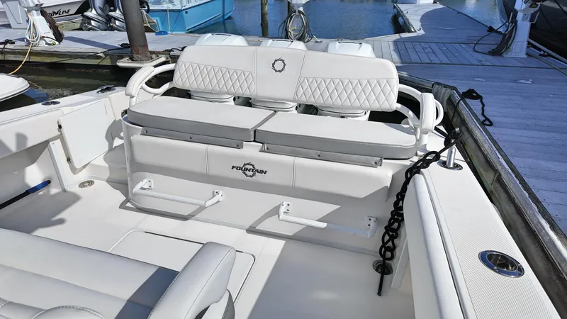  Yacht Photos Pics 2022 Fountain 38TE boat interior with white seating and dock view.