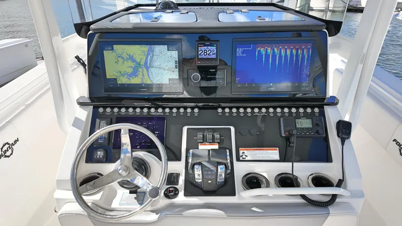  Yacht Photos Pics 2022 Fountain 38TE boat dashboard with navigation screens and controls.