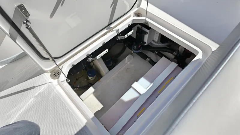  Yacht Photos Pics Open storage compartment on 2022 Fountain 38TE boat, showcasing internal components and structure.